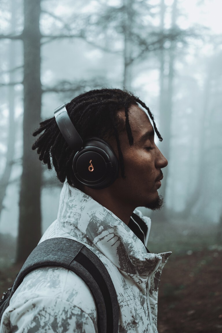 A man in a forest with headphones on