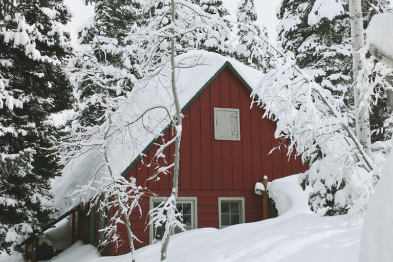A red house in Sweden in the snow at Christmas