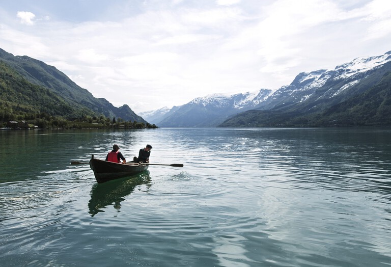 Two men on a boat in a fjord in Scandinavia