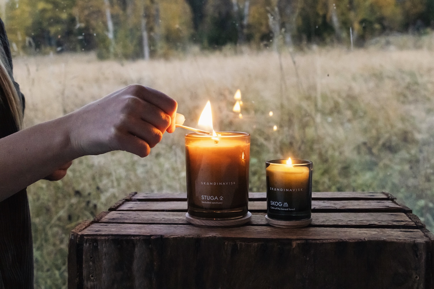 The small ritual of lighting a candle — the beginning of a slower evening.